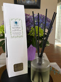 Sacred Space Reed Diffuser with packaging, styled with fresh flowers | New Moon Apothecary