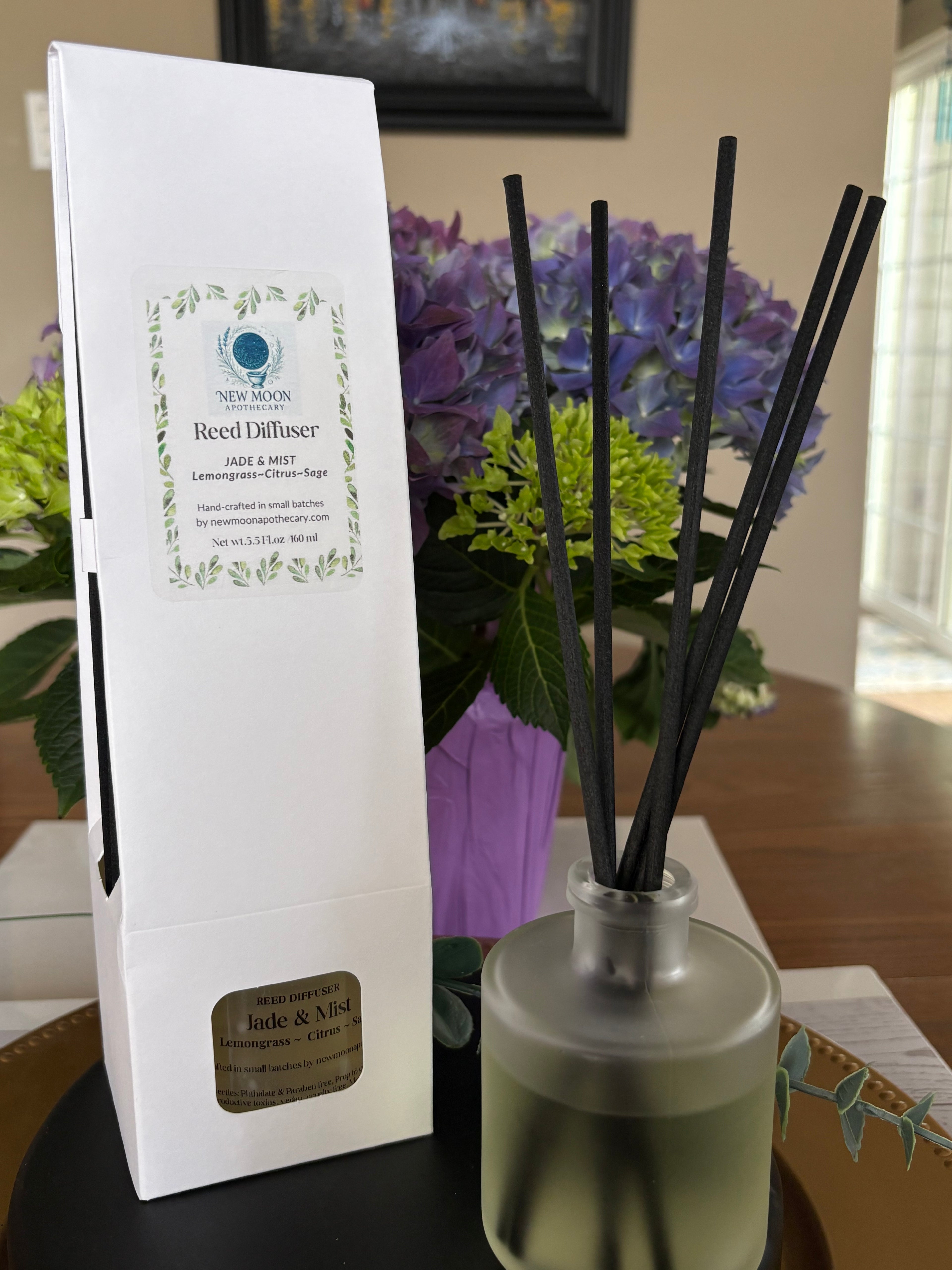 Sacred Space Reed Diffuser with packaging, styled with fresh flowers | New Moon Apothecary