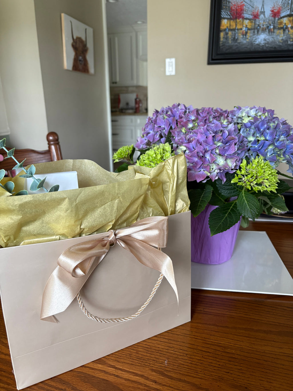 Sacred Space Soy Candle gift box with ribbon bow, styled next to a fresh flower bouquet | New Moon Apothecary