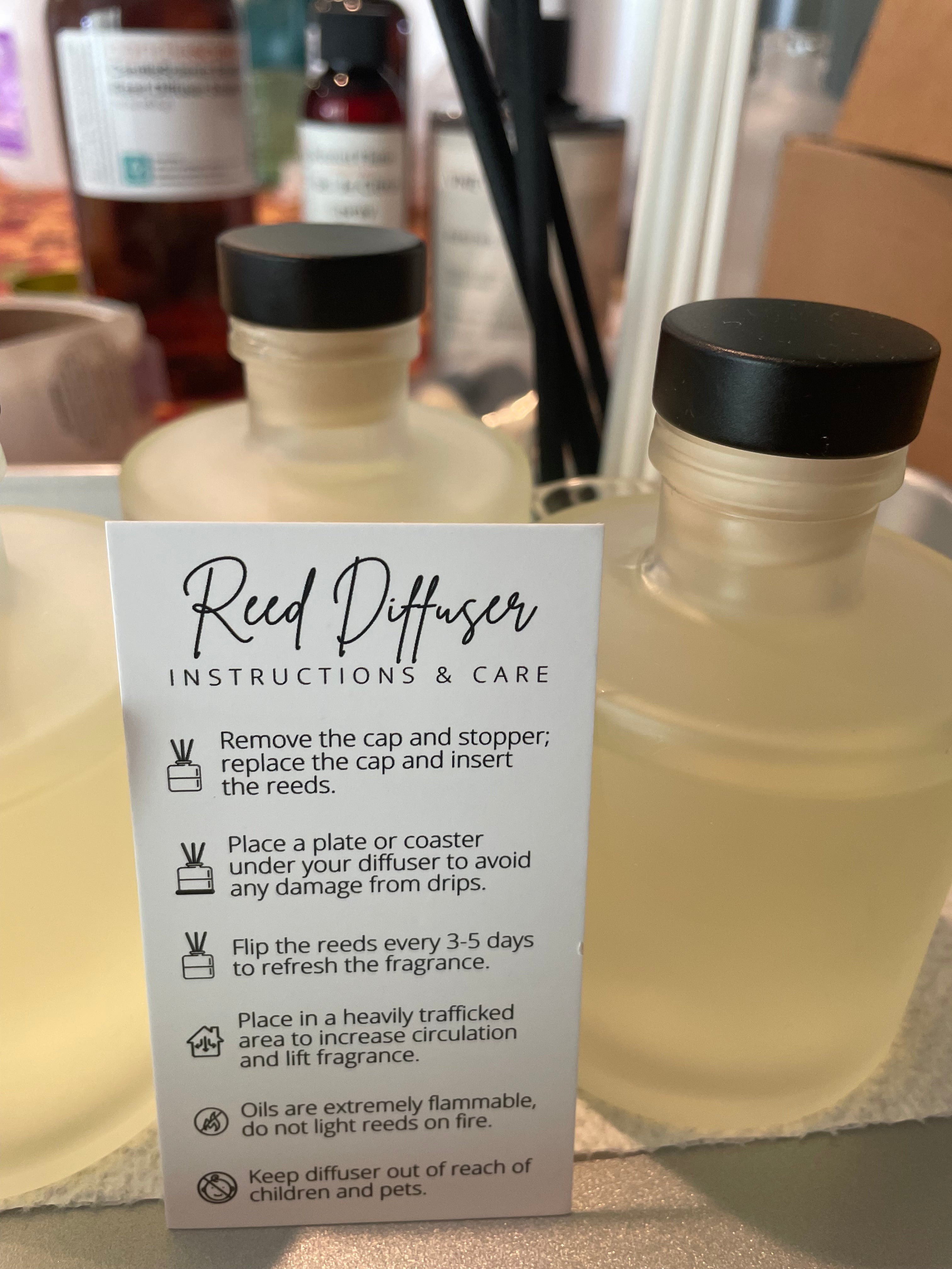 Reed diffuser with label showing instructions and care details on a blurred background