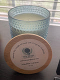 Sacred Space Soy Candle — Mediterranean scent in blue textured glass vessel with wooden lid on reflective surface | New Moon Apothecary