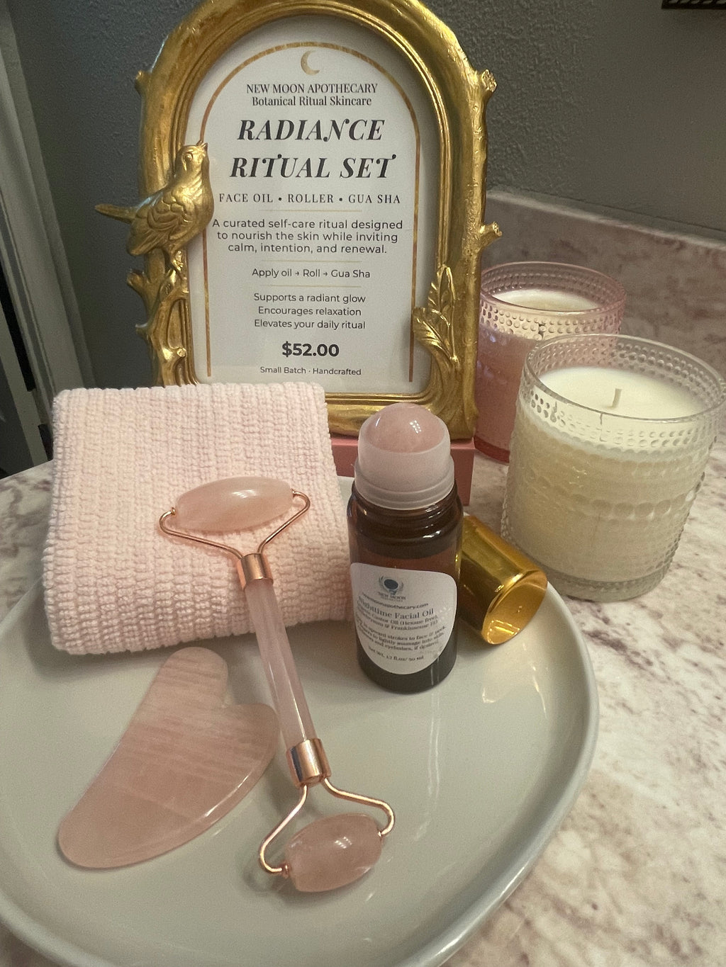 Skincare tools and products on a tray with a decorative frame in the background.
